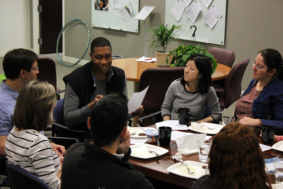 Researchers around a table discussion ideas 