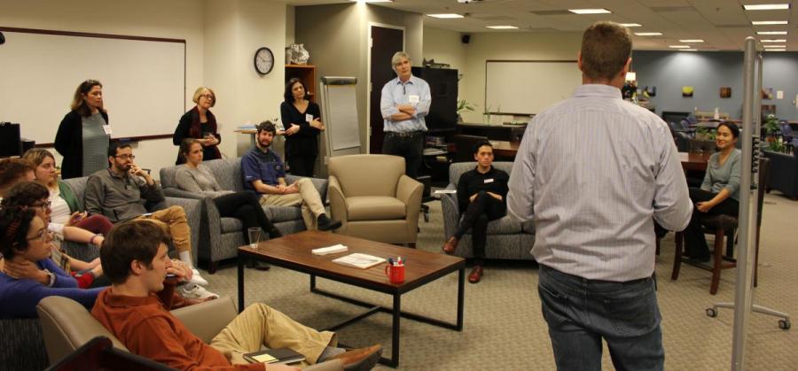 SESYNC postdocs seated engaged in a group discussed