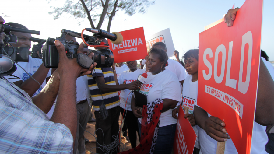 A group of people protesting land grabs being interviewed