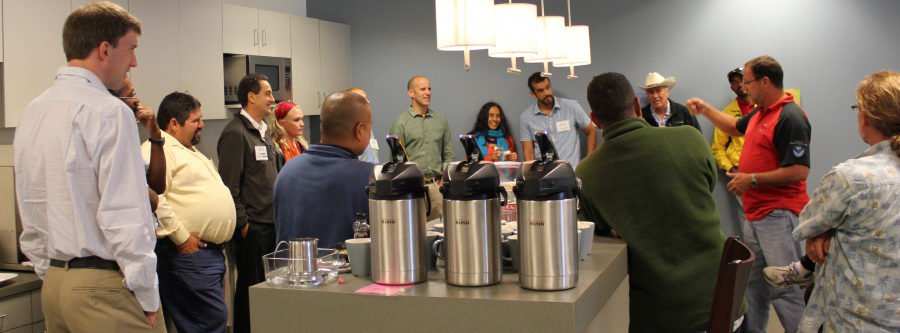 A team of researchers standing around having a discussion