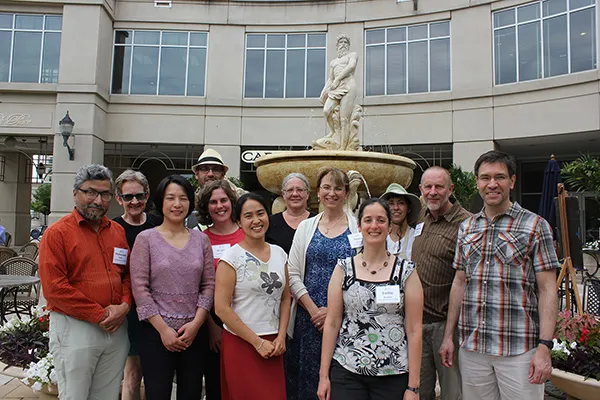 Participants of the "Moving Towards Best Practices" workshop gathered in front of a water fountain outside SESYNC