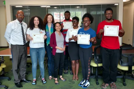 Coppin State students gathered holding certificates 