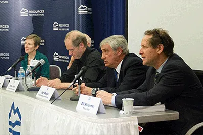 Four panelists sitting at a table
