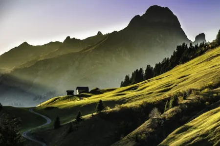 A landscape view of a mountainside with another mountain in the background