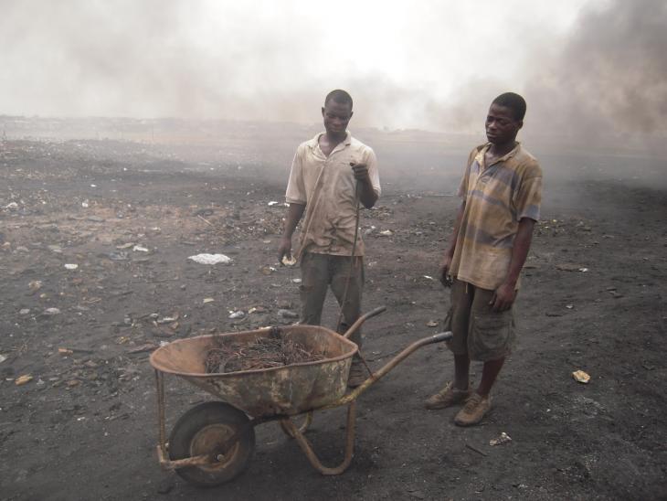 two men work at an e-waste site
