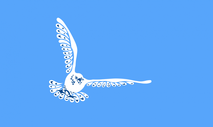 Inuvialuit flag--light blue background, stylized white bird with wings out stretched