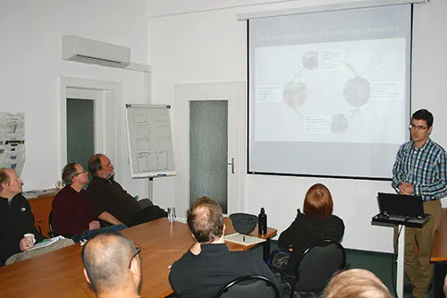Neil Carter standing in front of a small group of people presenting research on a screen